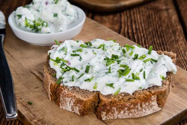 Toast topped with creamy goat cheese and minced herbs