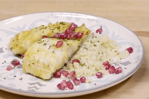 White plate with frets with codfish marinated with couscous and pomegranate