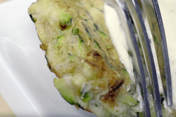 Dish detail of Zucchini fritters with yogurt sauce 