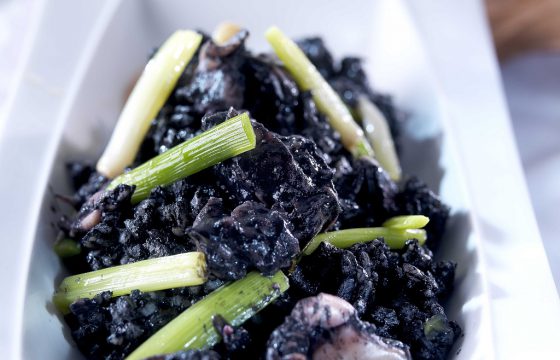 Black rice with baby cuttlefish and green garlic