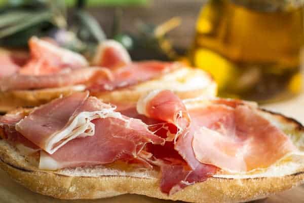 Toasted bread with Spanish ham on a plate is the perfect breakfast or snack.